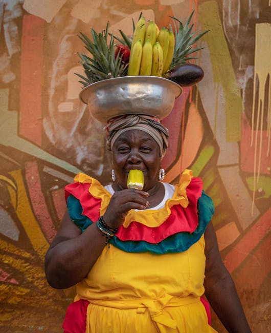 A person confidently choosing a ripe pineapple at a market, surrounded by other fresh fruits