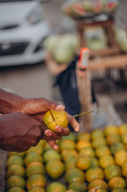 A sunny market scene with a fresh pile of golden pineapples