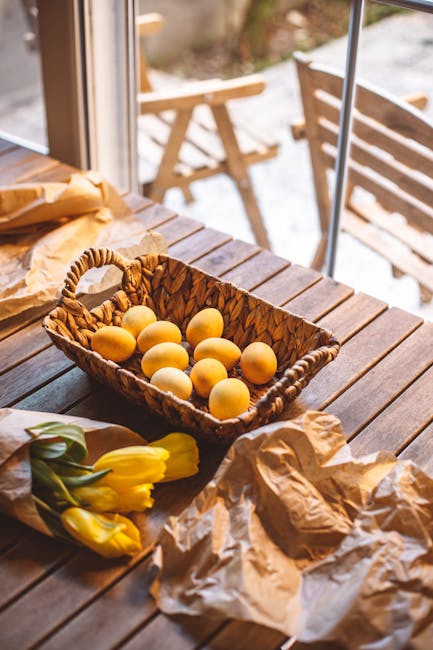 Pineapples in a decorative fruit basket on a sunlit dining table