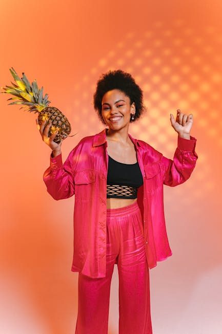 Blender full of vibrant fruits and frozen pineapple chunks ready to be blended